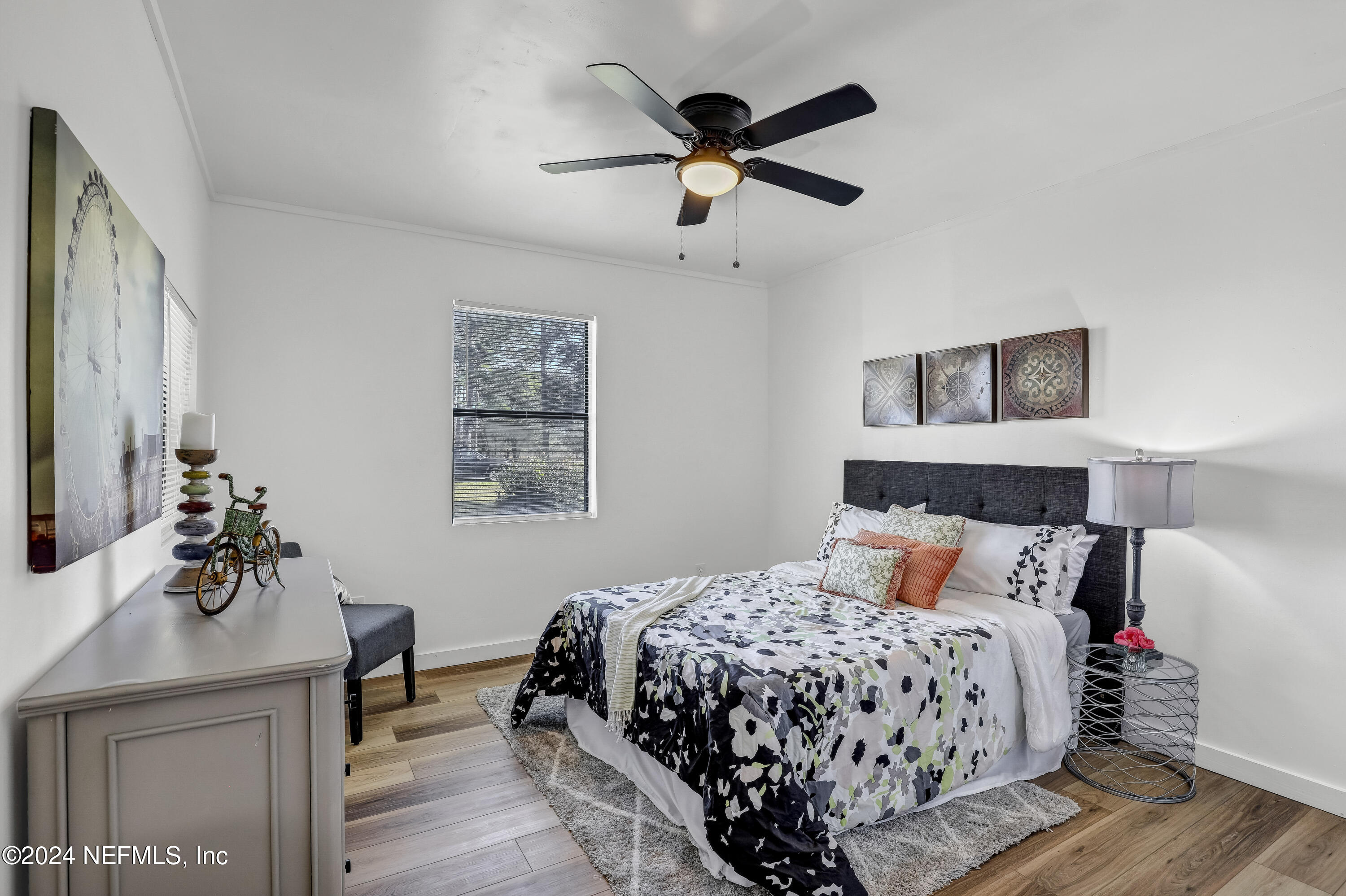 54221 Cravey Road Callahan, FL 32011 - Photo 30 of 52 a bedroom with a bed and wooden floor