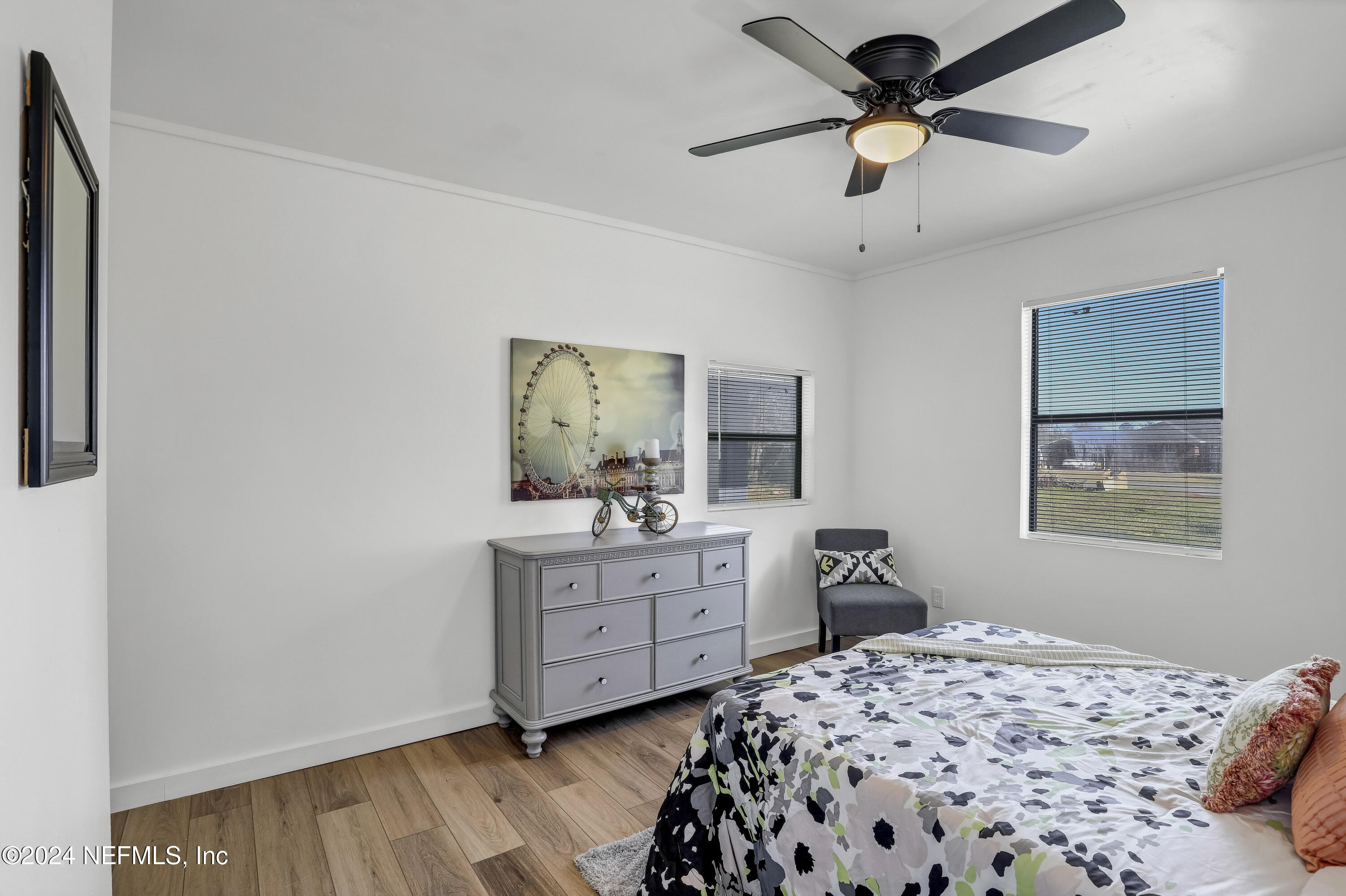 54221 Cravey Road Callahan, FL 32011 - Photo 31 of 52 a bedroom with a bed and a chandelier