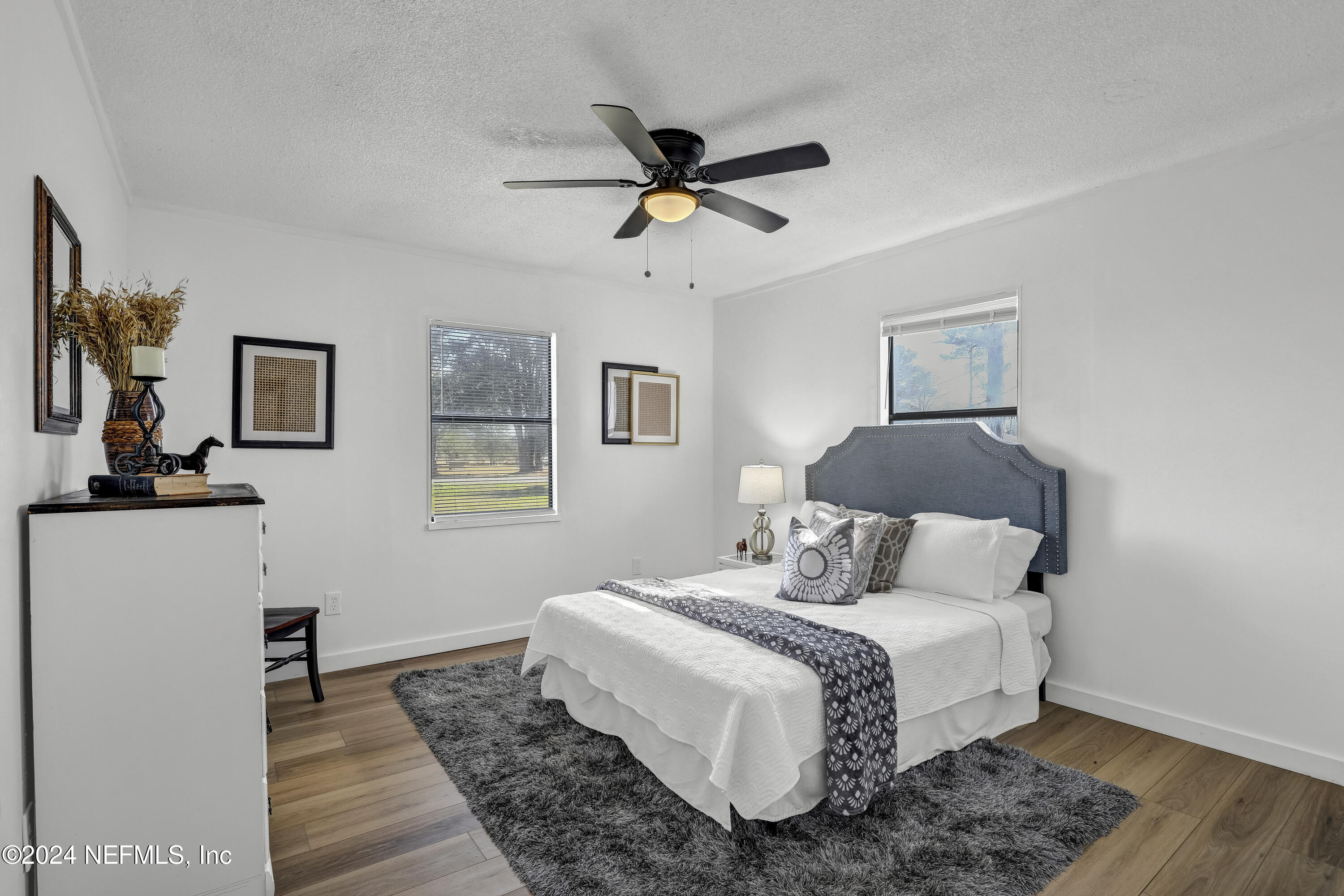 54221 Cravey Road Callahan, FL 32011 - Photo 35 of 52 a bedroom with a bed and wooden floor