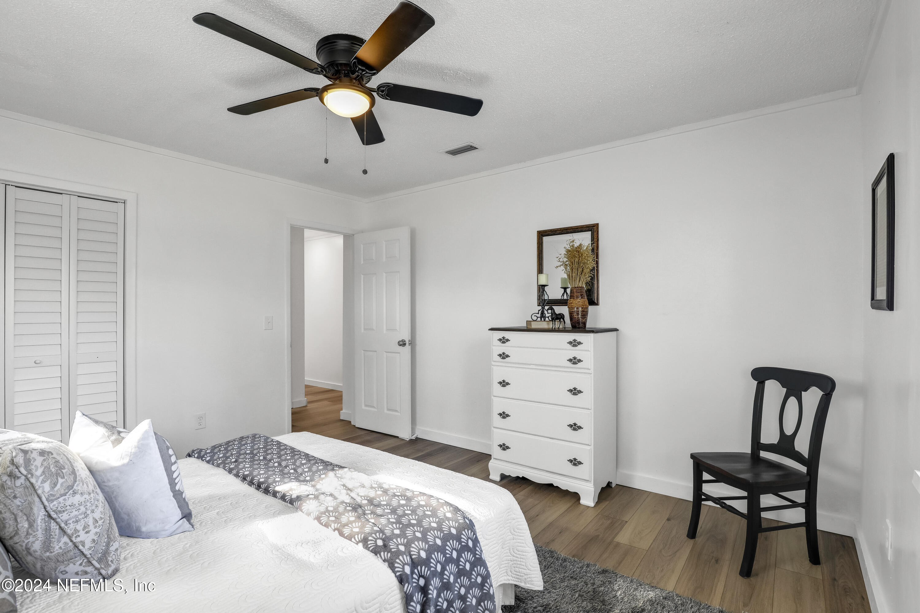 54221 Cravey Road Callahan, FL 32011 - Photo 36 of 52 a bedroom with a bed and a chair