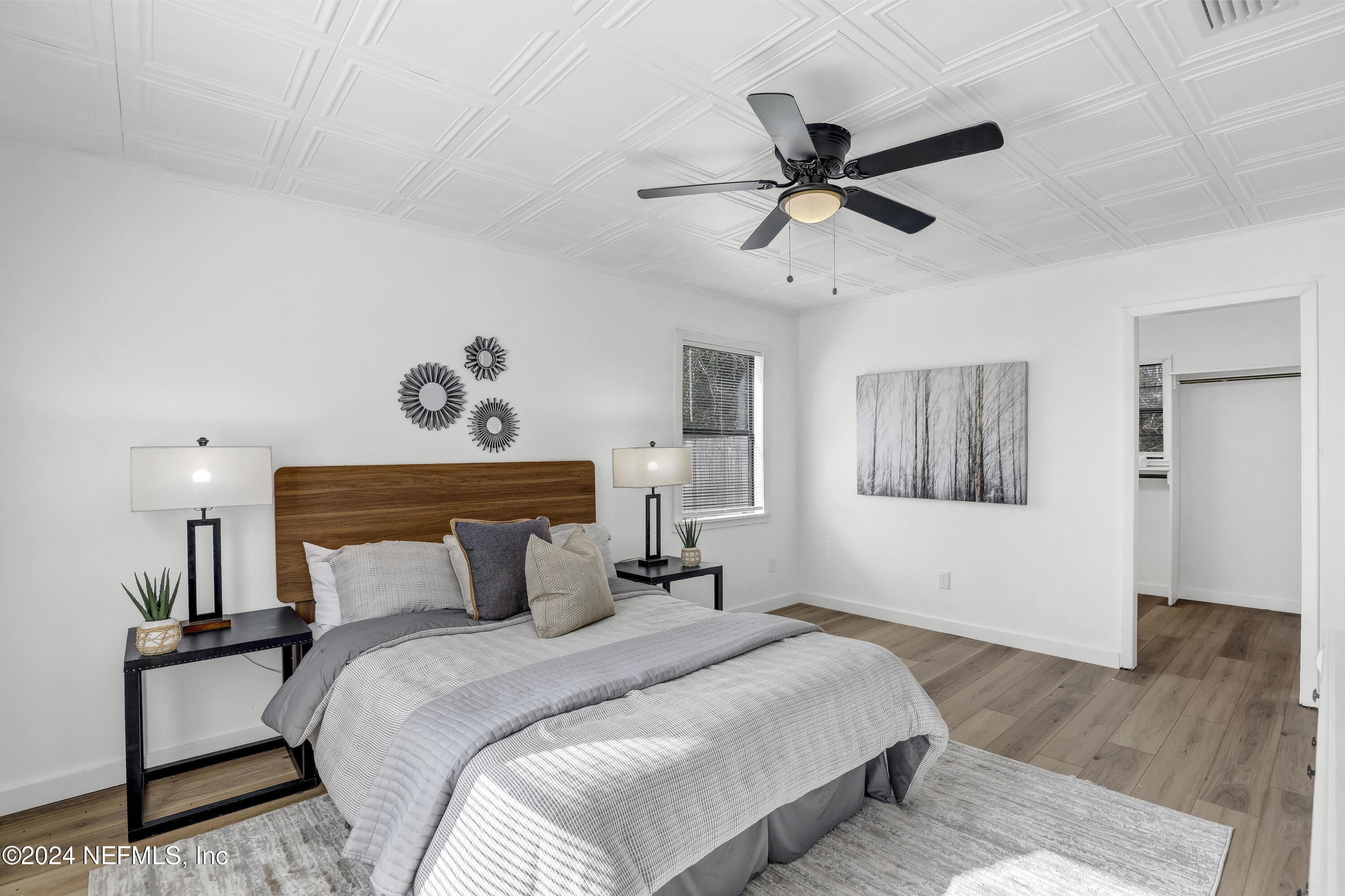 54221 Cravey Road Callahan, FL 32011 - Photo 41 of 52 a bedroom with a bed and wooden floor