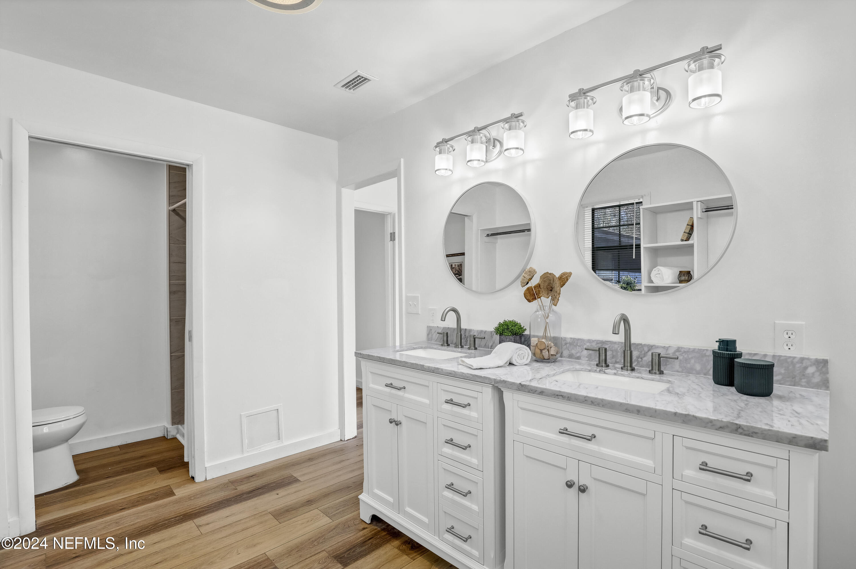 54221 Cravey Road Callahan, FL 32011 - Photo 44 of 52 a bathroom with a double vanity sink and a mirror