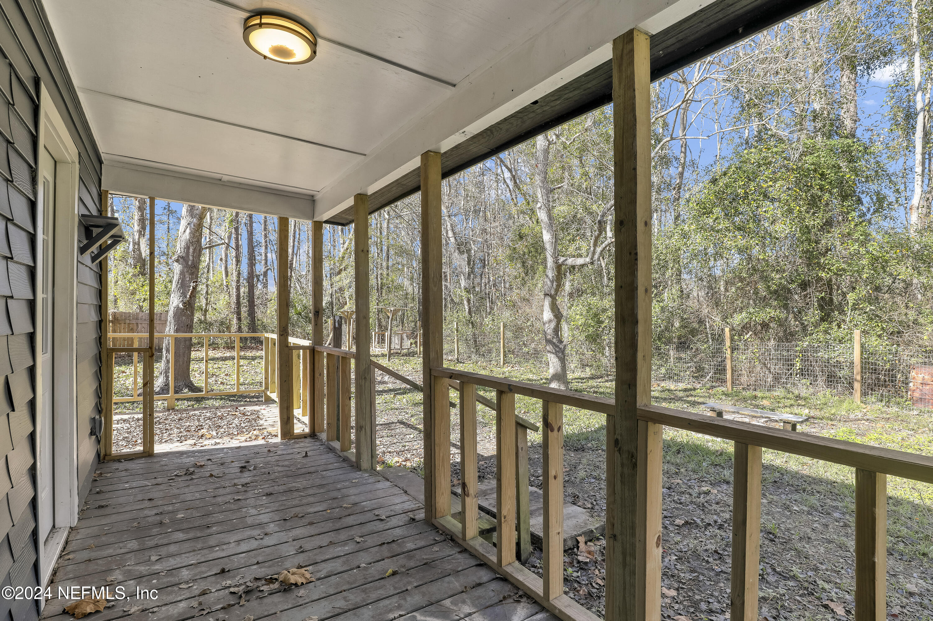 54221 Cravey Road Callahan, FL 32011 - Photo 46 of 52 a view of hallway with wooden floor and door