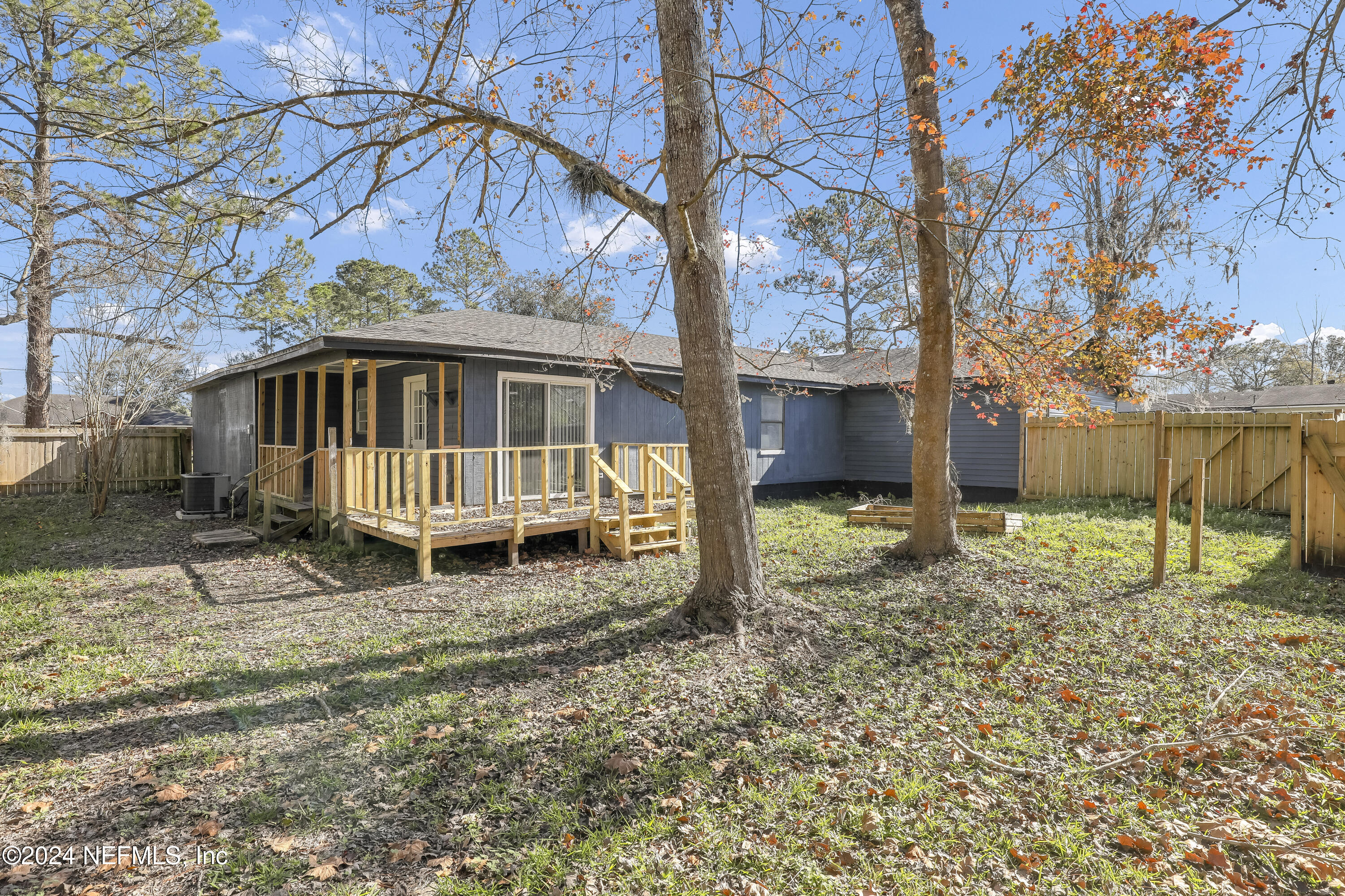 54221 Cravey Road Callahan, FL 32011 - Photo 50 of 52 a backyard of a house with wooden fence and porch