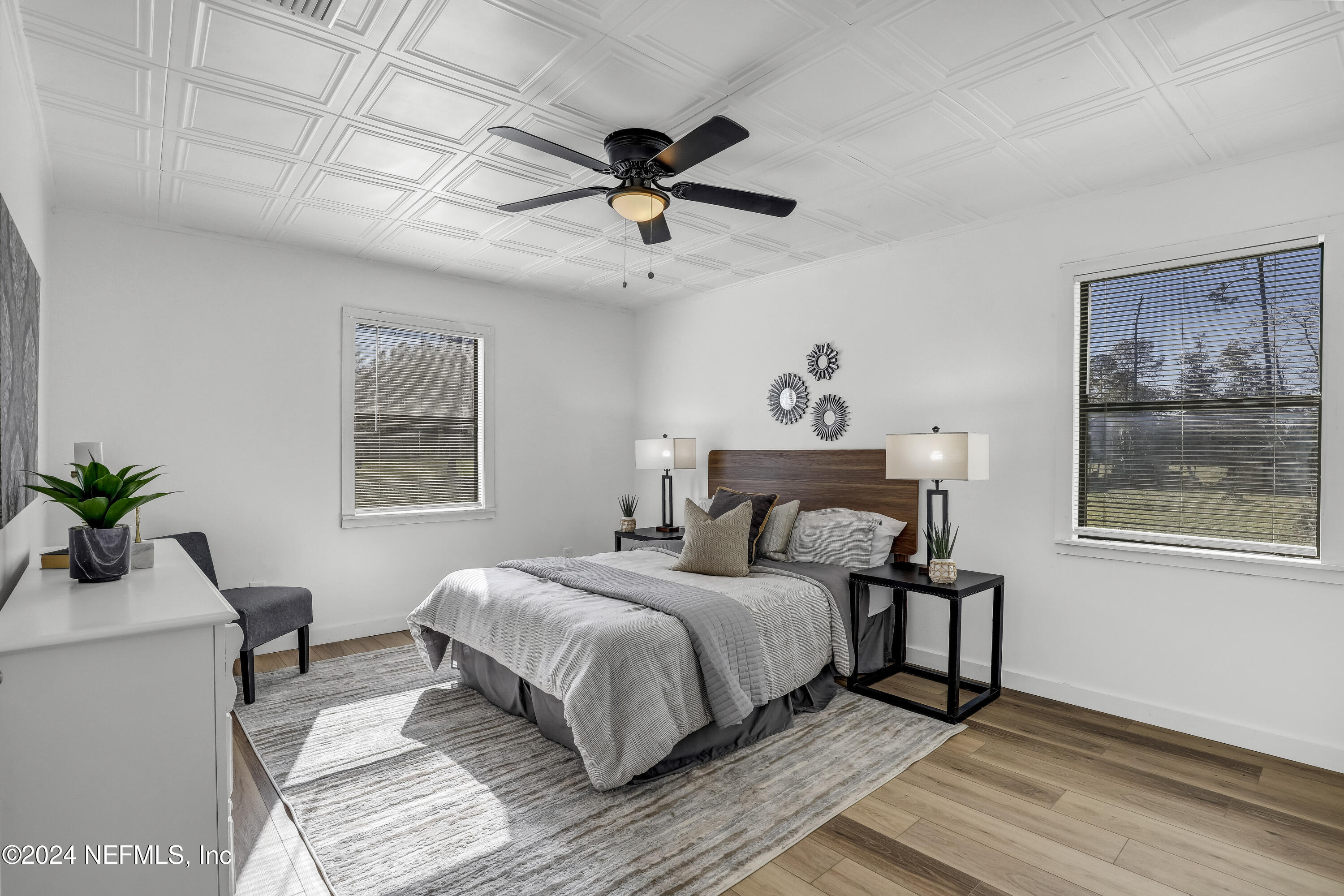 54221 Cravey Road Callahan, FL 32011 - Photo 6 of 52 a bedroom with a bed and a chandelier