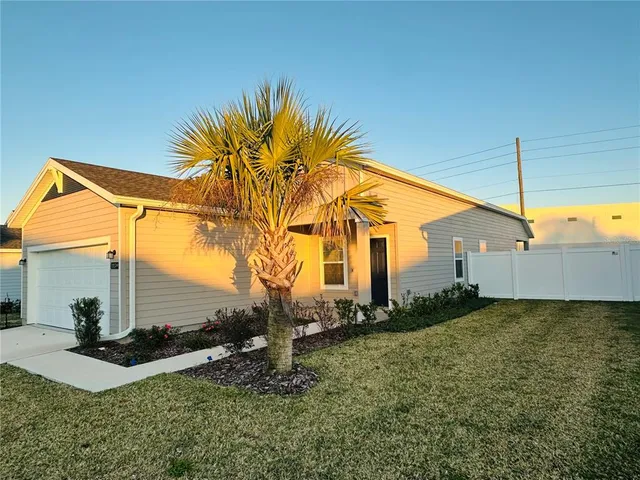 a view of a house with a backyard