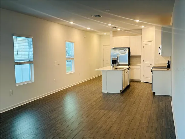 a kitchen with a sink and a refrigerator