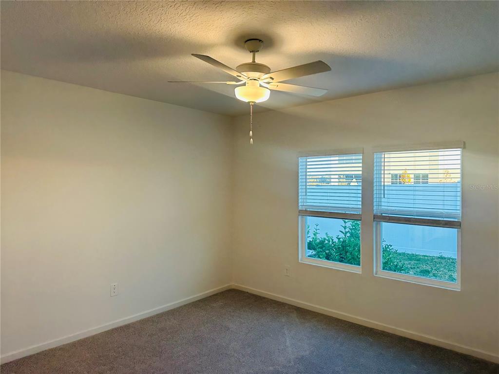 1139 Northwest 44th Court Road Ocala, FL 34482 - Photo 16 of 36 an empty room with windows and ceiling fan