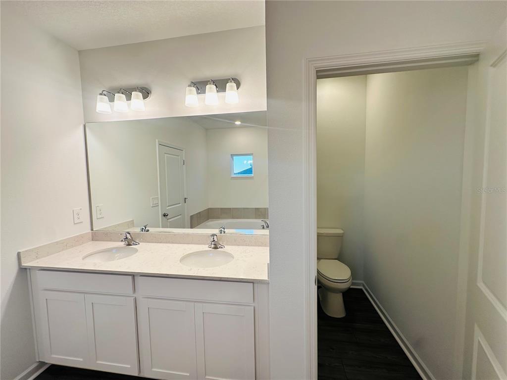 1139 Northwest 44th Court Road Ocala, FL 34482 - Photo 21 of 36 a bathroom with a sink a toilet and a mirror