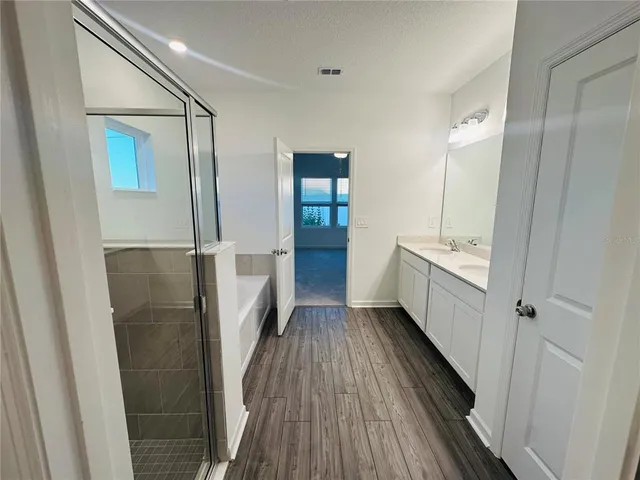a bathroom with a bathtub and a sink