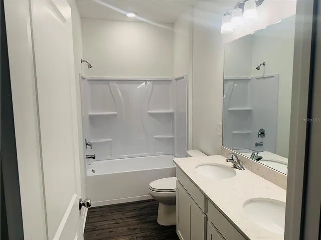 a bathroom with a sink toilet tub and shower