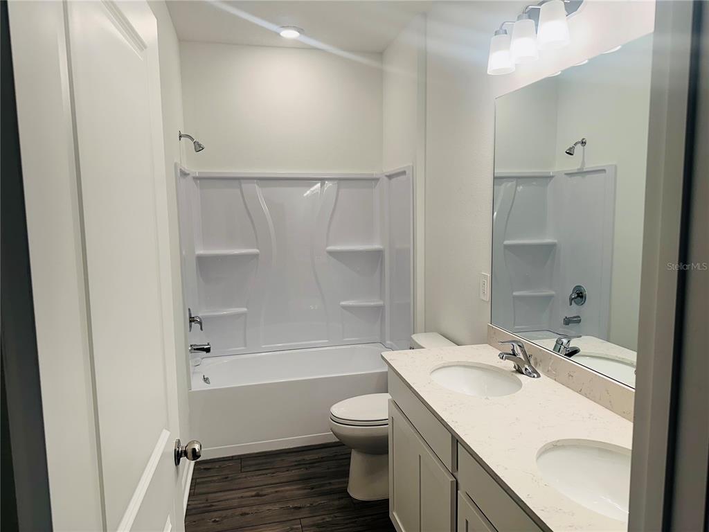1139 Northwest 44th Court Road Ocala, FL 34482 - Photo 28 of 36 a bathroom with a sink toilet tub and shower