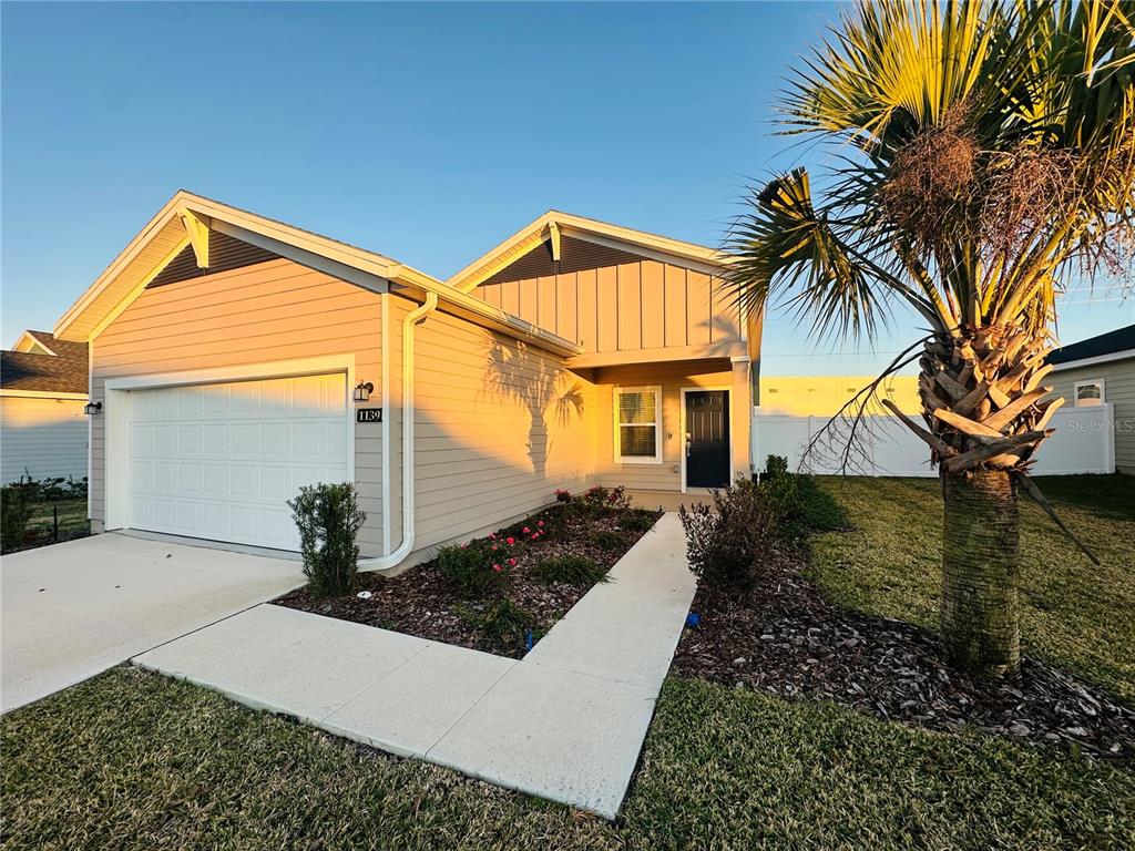 1139 Northwest 44th Court Road Ocala, FL 34482 - Photo 3 of 36 a front view of a house with garden