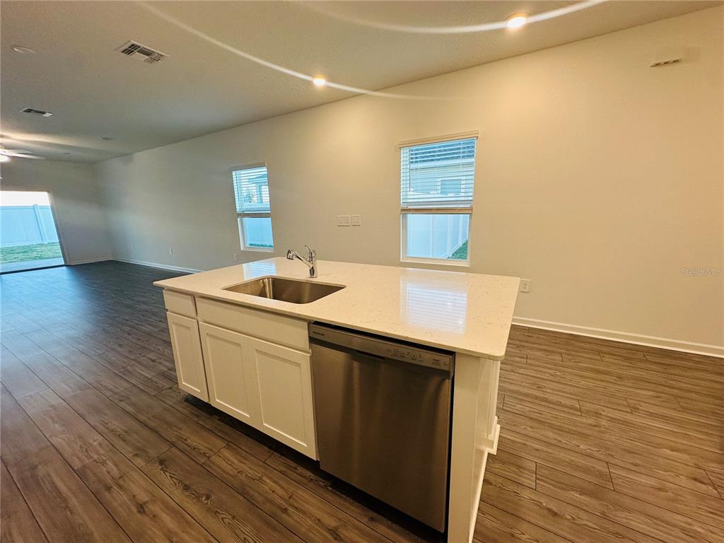 1139 Northwest 44th Court Road Ocala, FL 34482 - Photo 9 of 36 a kitchen with a sink cabinets and wooden floor
