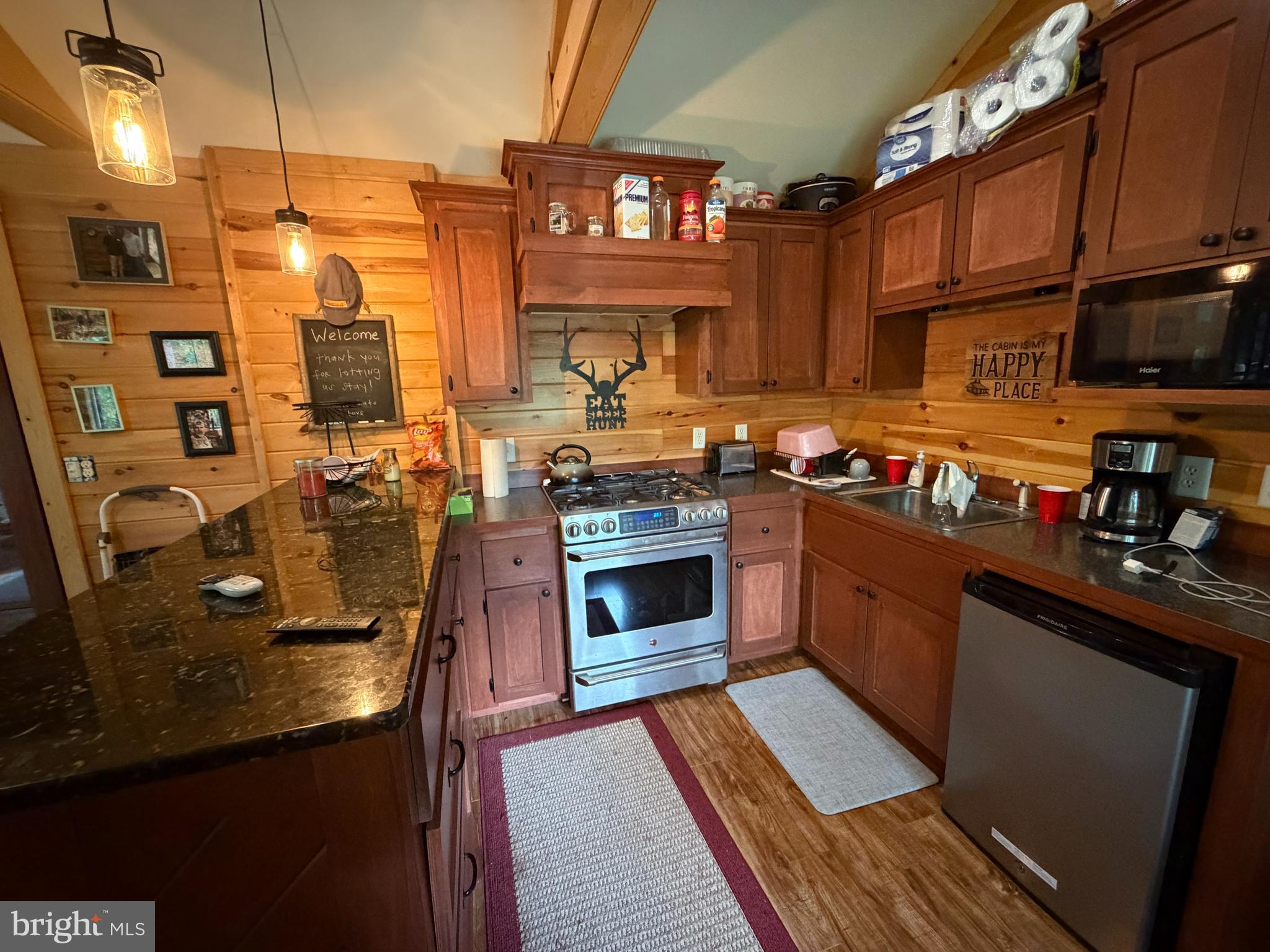 1419 Paul's Woods Road Delray, WV 26714 - Photo 16 of 105 a kitchen with stainless steel appliances granite countertop a stove a sink and a microwave
