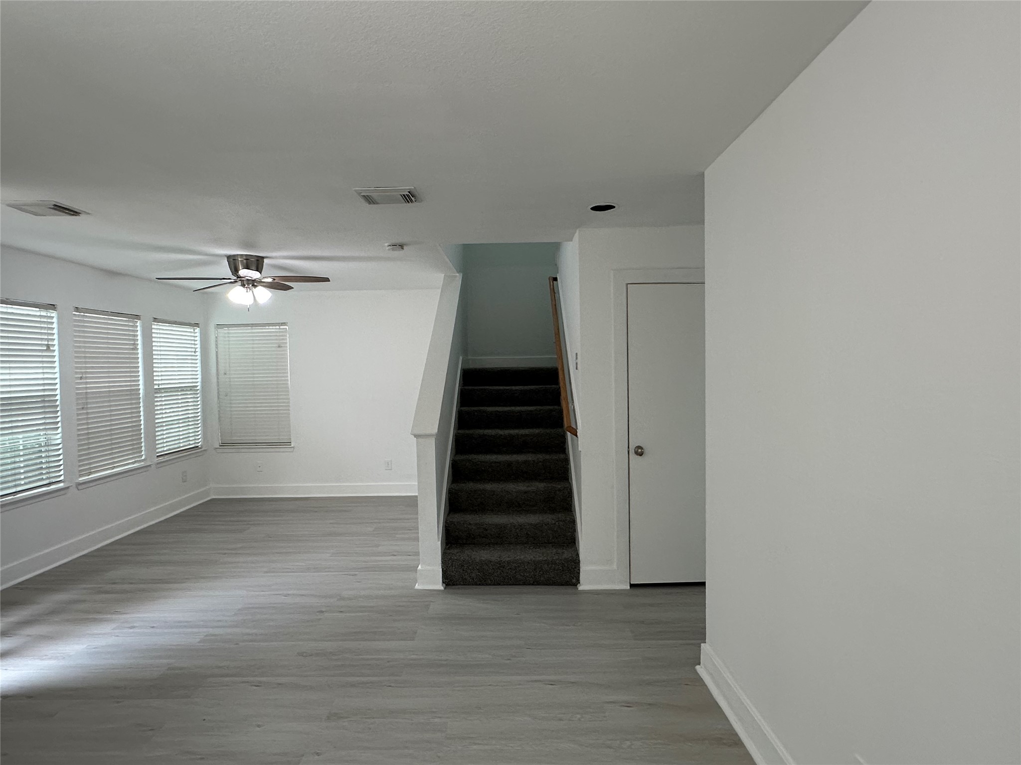 7430 Rabbit Ridge Missouri City, TX 77459 - Photo 11 of 17 a view of a hallway with stairs and wooden floor