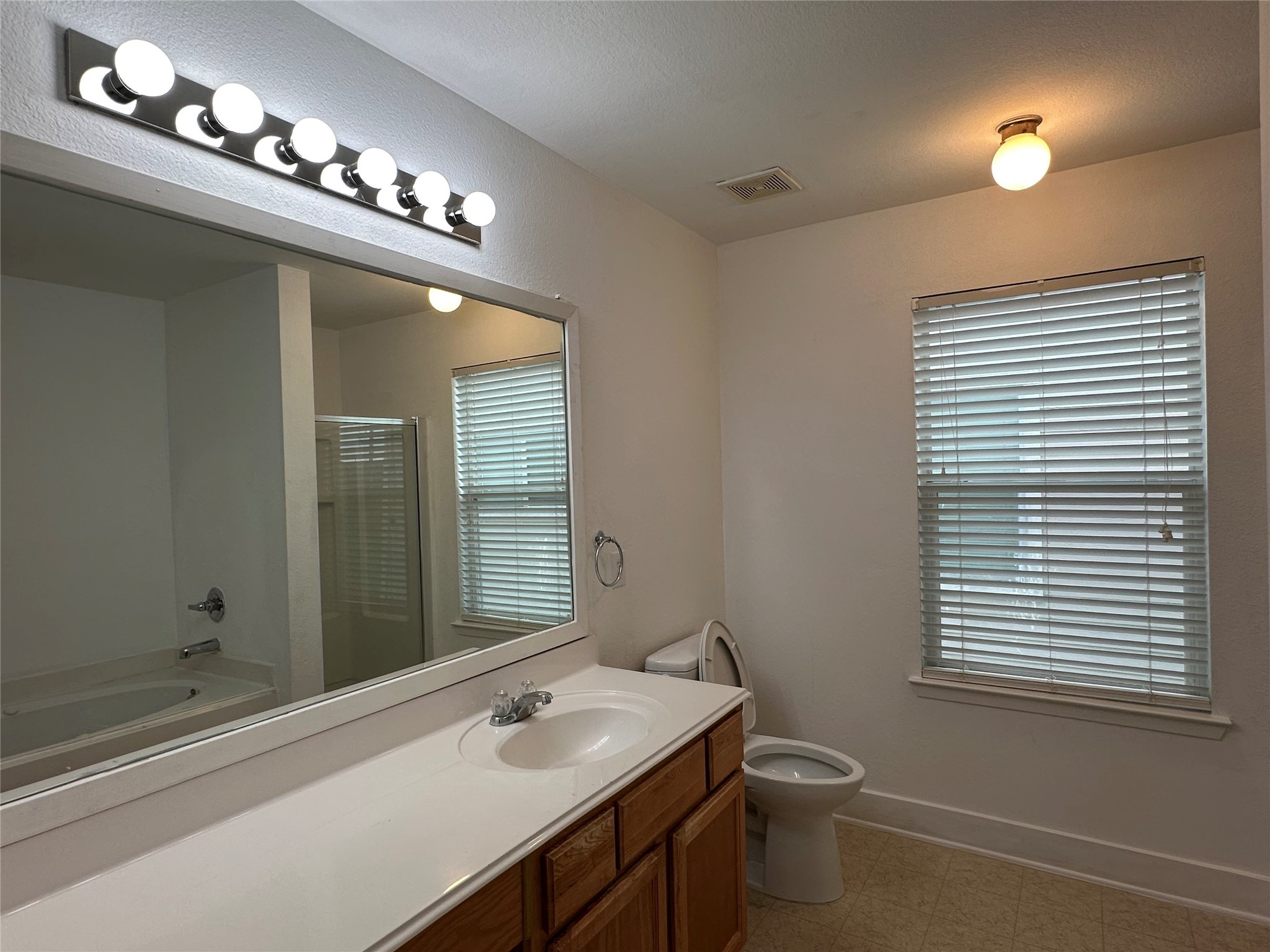 7430 Rabbit Ridge Missouri City, TX 77459 - Photo 14 of 17 a bathroom with a sink a toilet and a mirror
