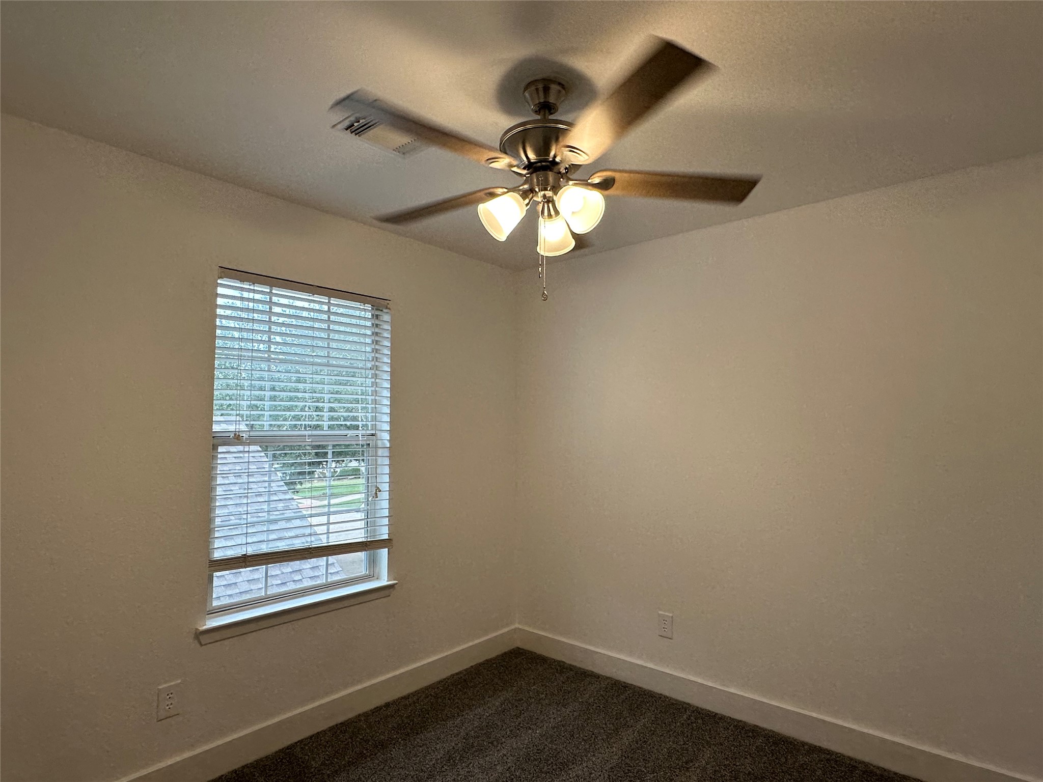 7430 Rabbit Ridge Missouri City, TX 77459 - Photo 15 of 17 an empty room with a window and a fan