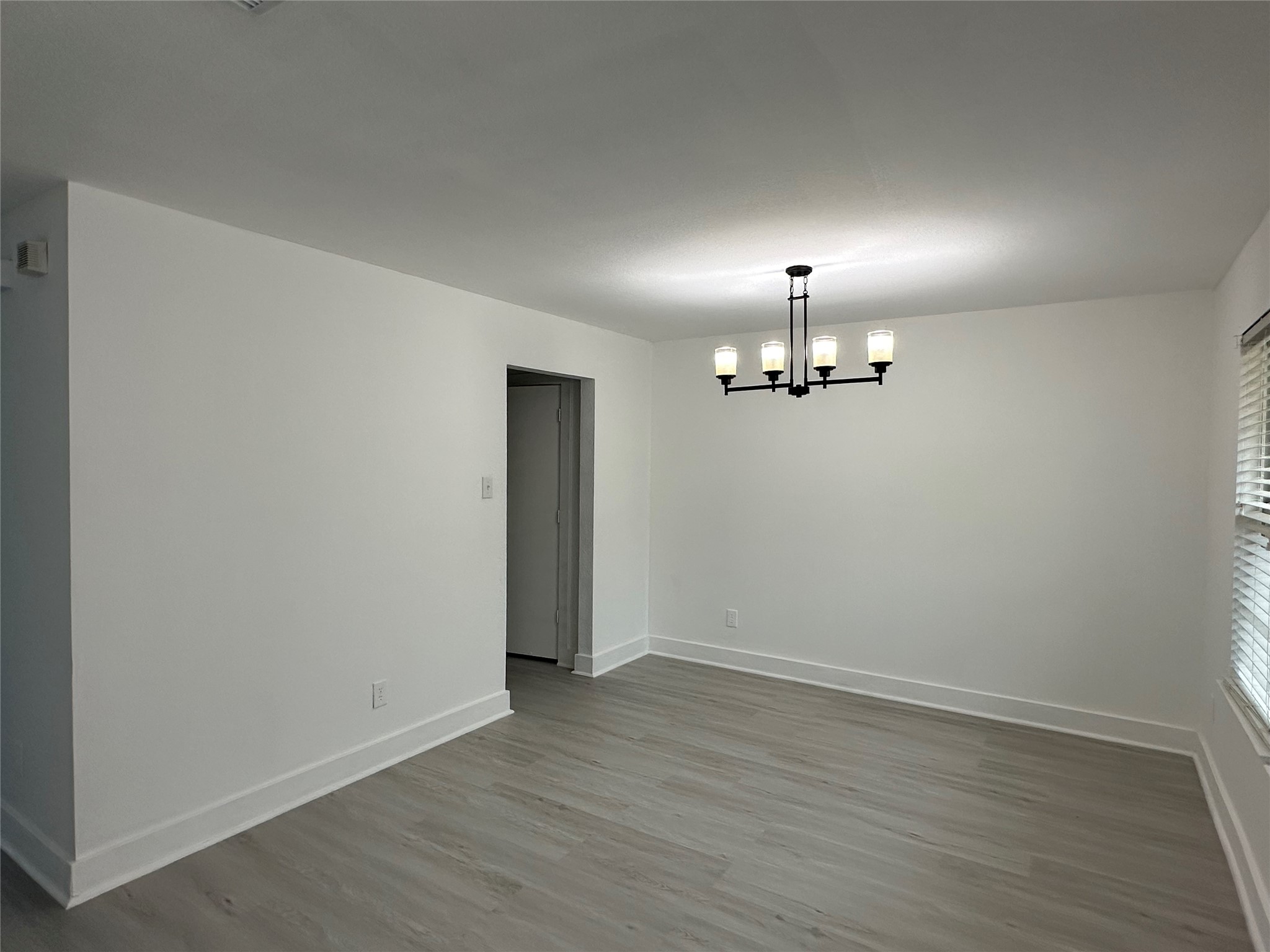 7430 Rabbit Ridge Missouri City, TX 77459 - Photo 4 of 17 an empty room with wooden floor ceiling fan and windows