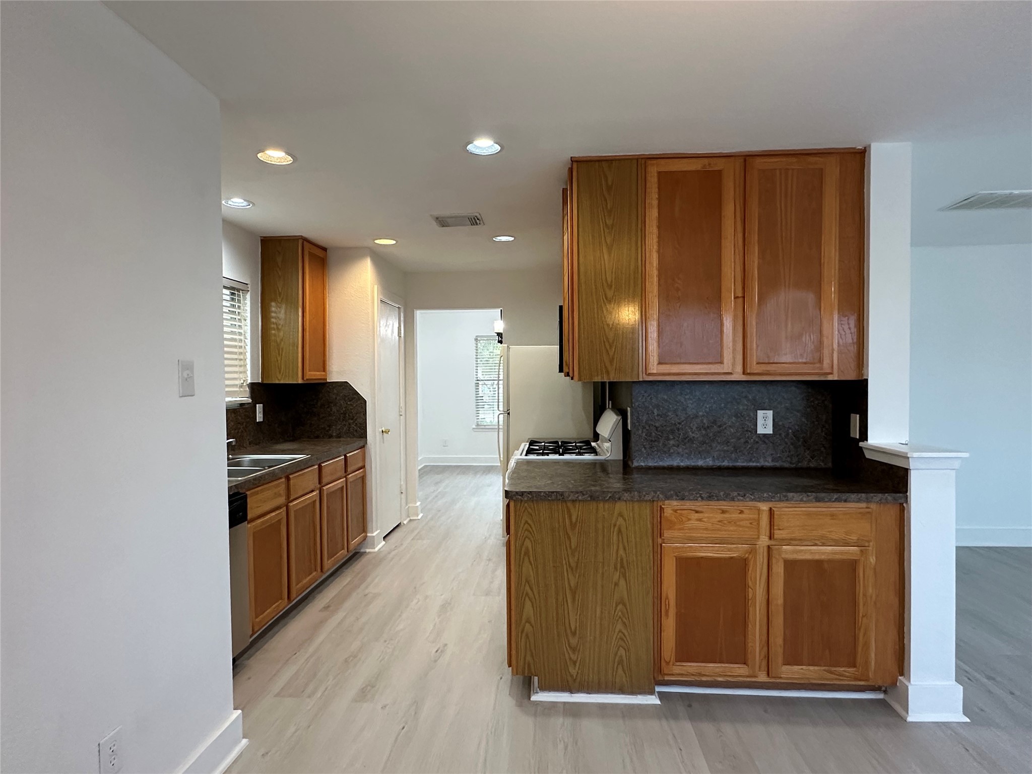 7430 Rabbit Ridge Missouri City, TX 77459 - Photo 9 of 17 a kitchen with stainless steel appliances granite countertop a stove a sink and a microwave