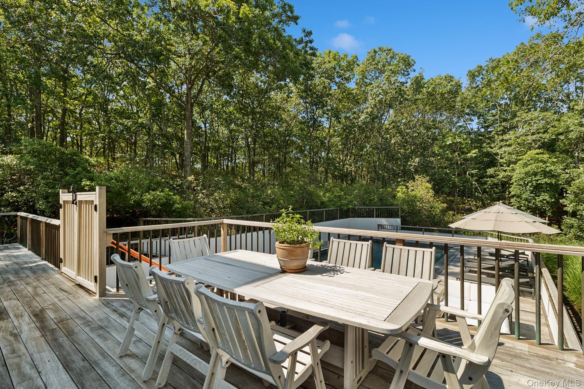 28 Ridge Road Wainscott, NY 11937 - Photo 11 of 40 a view of a table and chairs on the roof deck