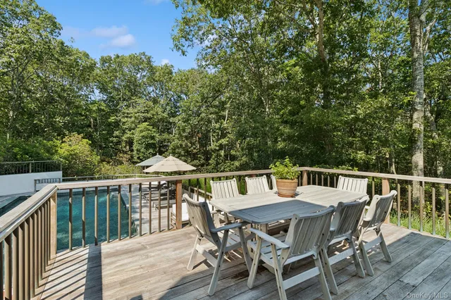 a view of a dinning table and chairs on the roof deck
