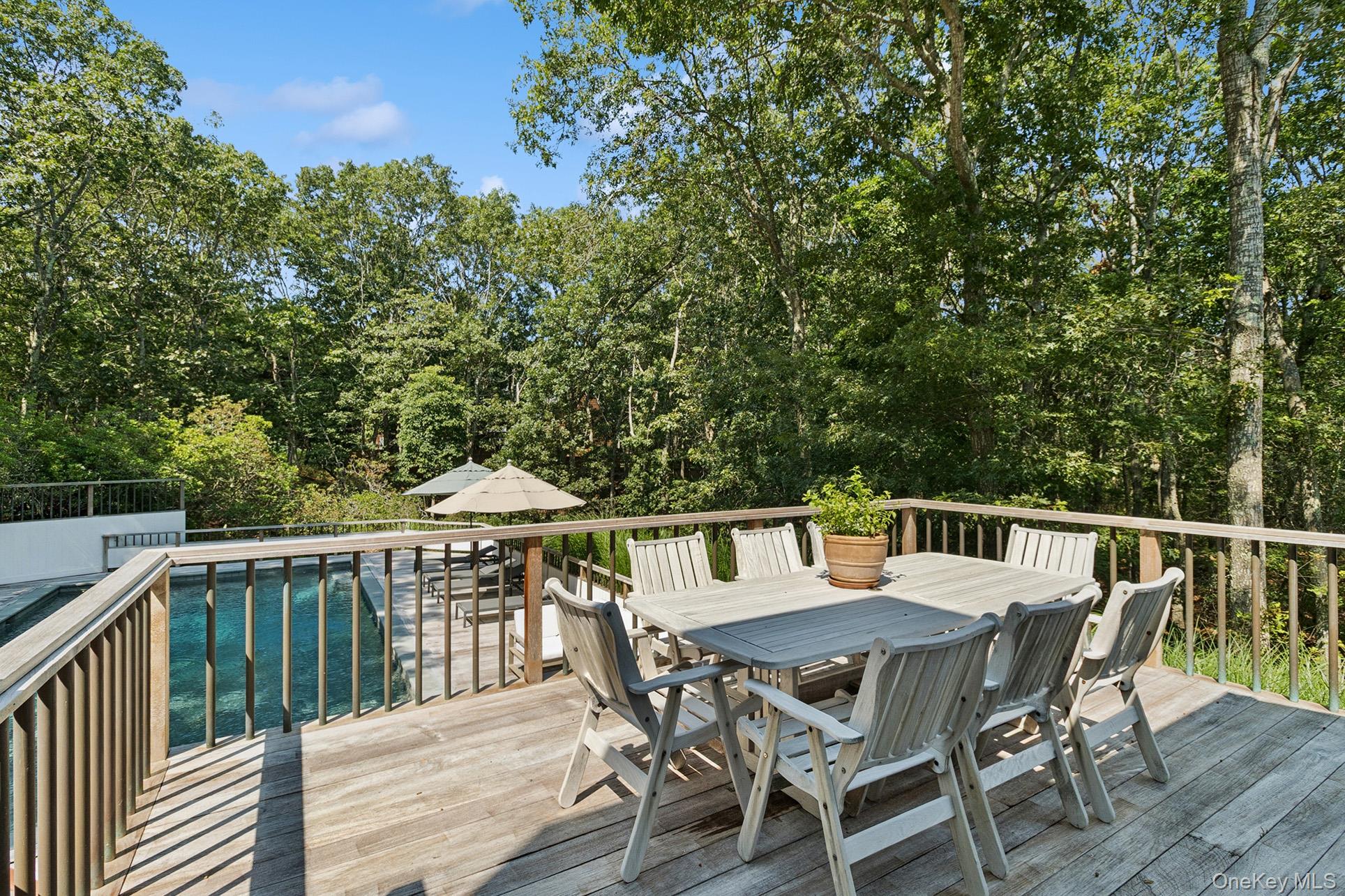 28 Ridge Road Wainscott, NY 11937 - Photo 14 of 40 a view of a dinning table and chairs on the roof deck