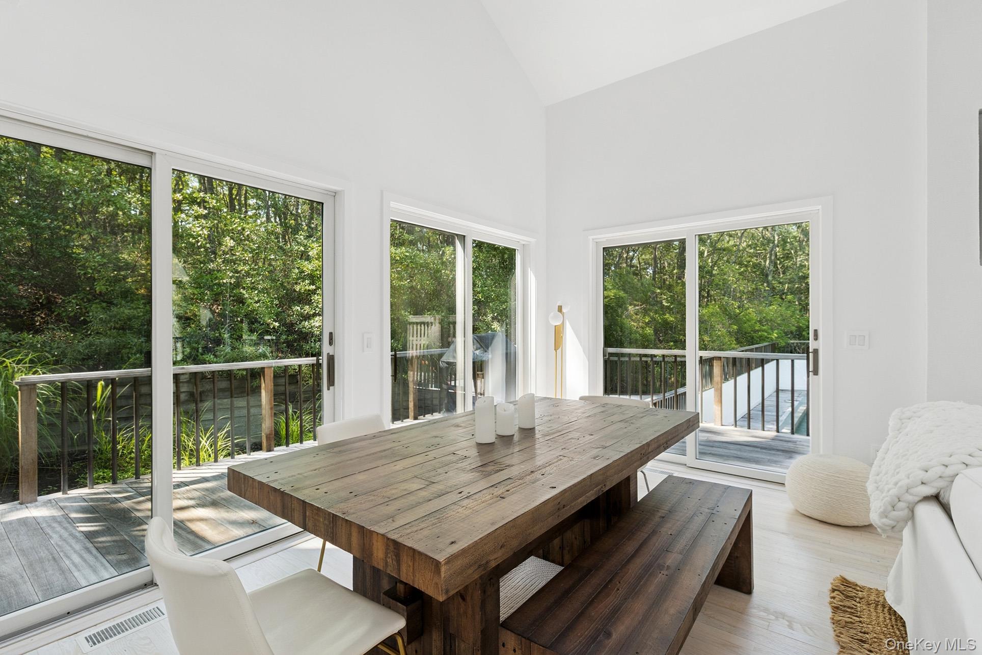 28 Ridge Road Wainscott, NY 11937 - Photo 21 of 40 a view of a living room with large windows and wooden floor