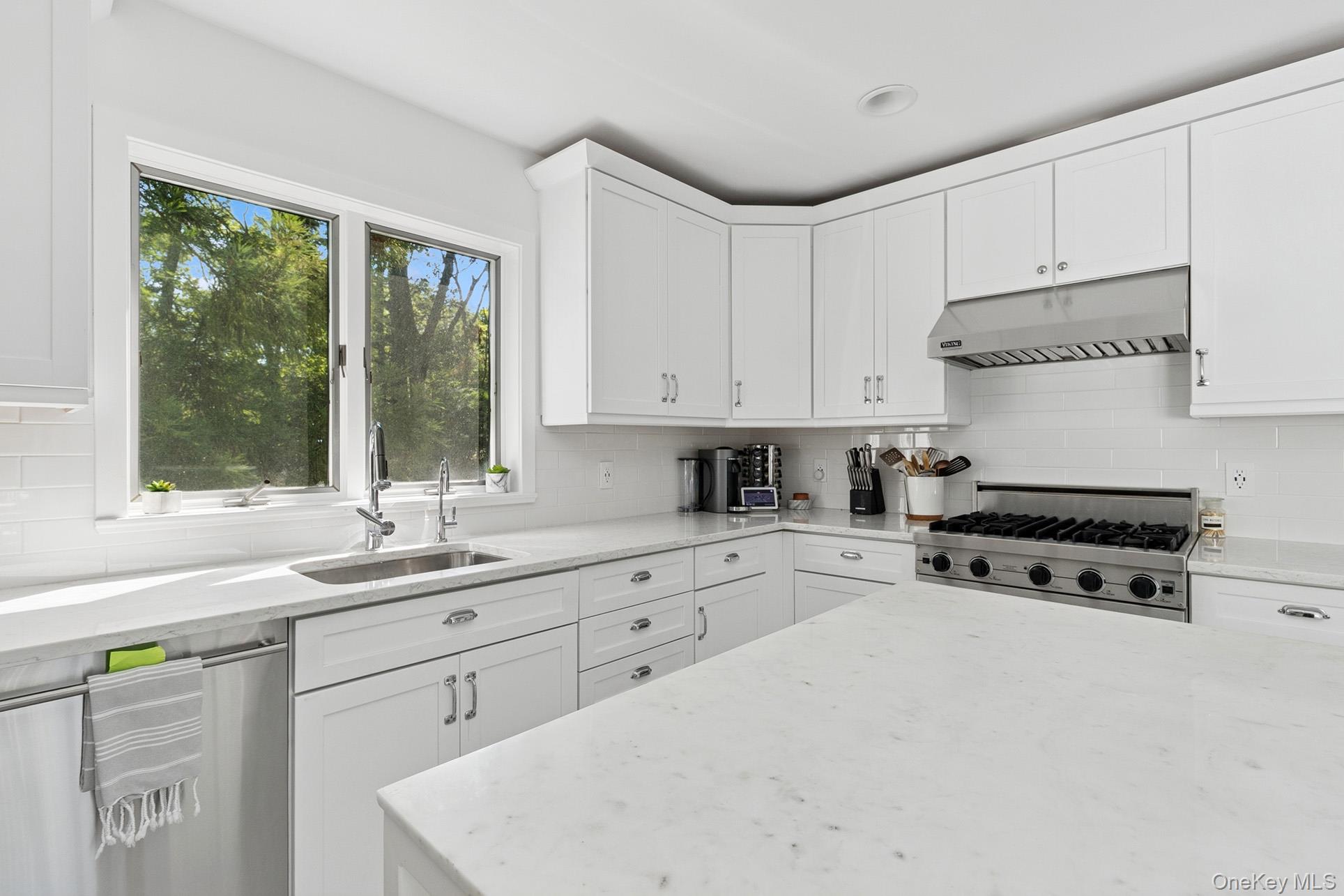 28 Ridge Road Wainscott, NY 11937 - Photo 29 of 40 a kitchen with granite countertop white cabinets and white appliances