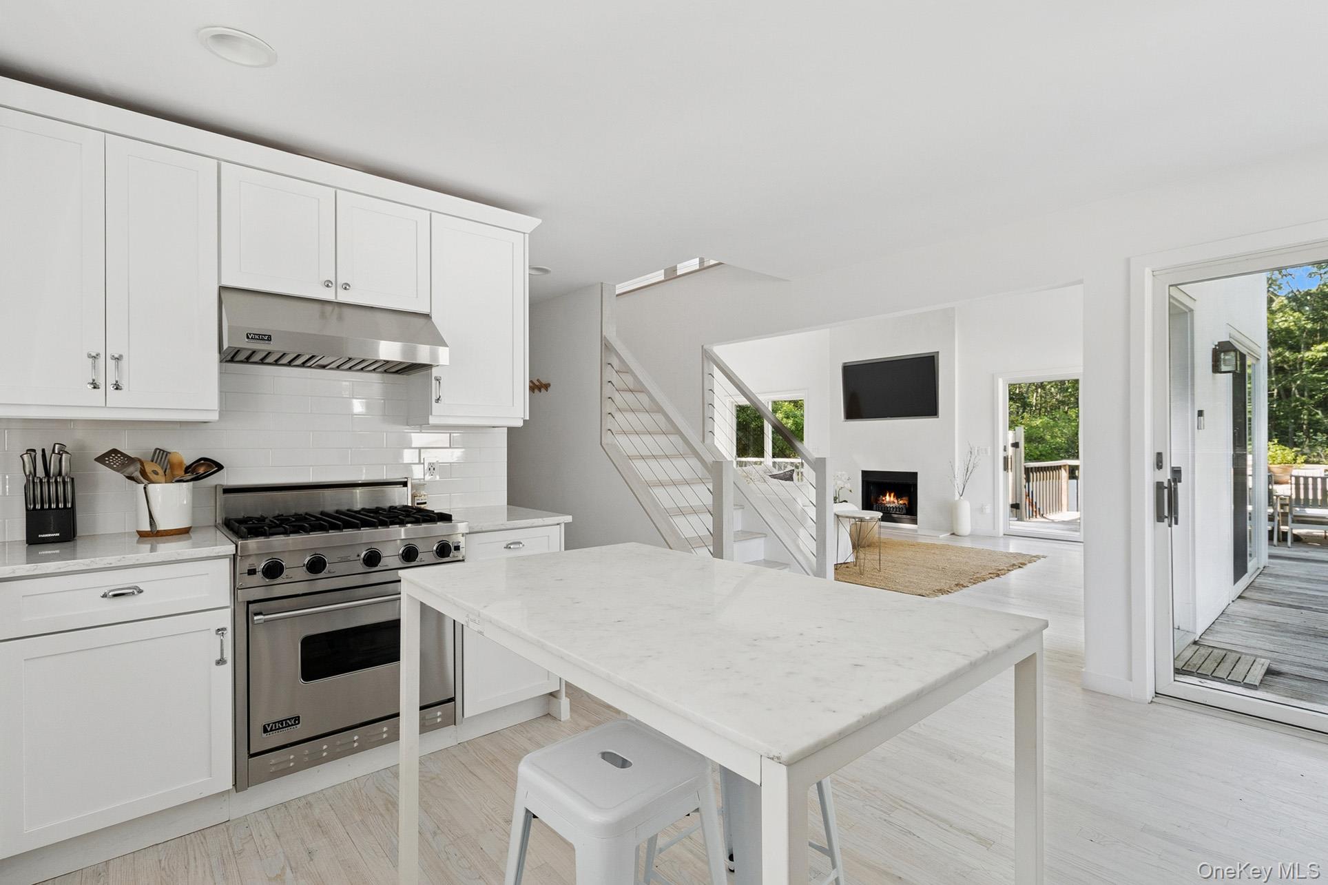 28 Ridge Road Wainscott, NY 11937 - Photo 30 of 40 a kitchen with white cabinets and appliances