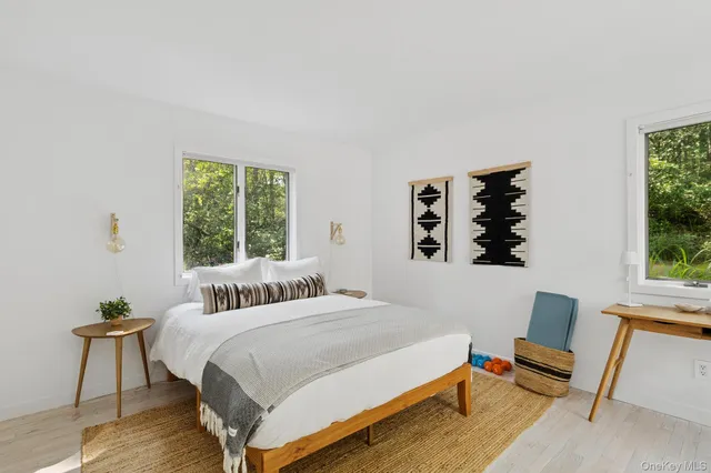a bedroom with furniture and a large window