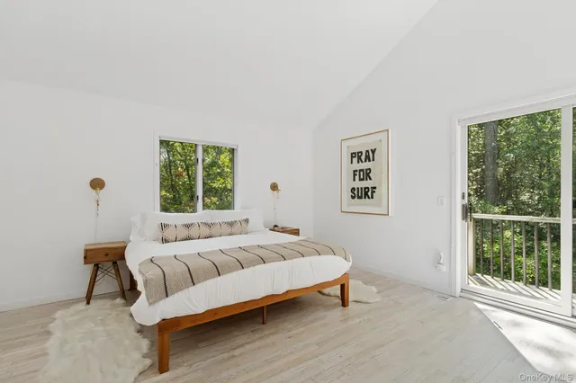 a view of a livingroom with wooden floor and stairs