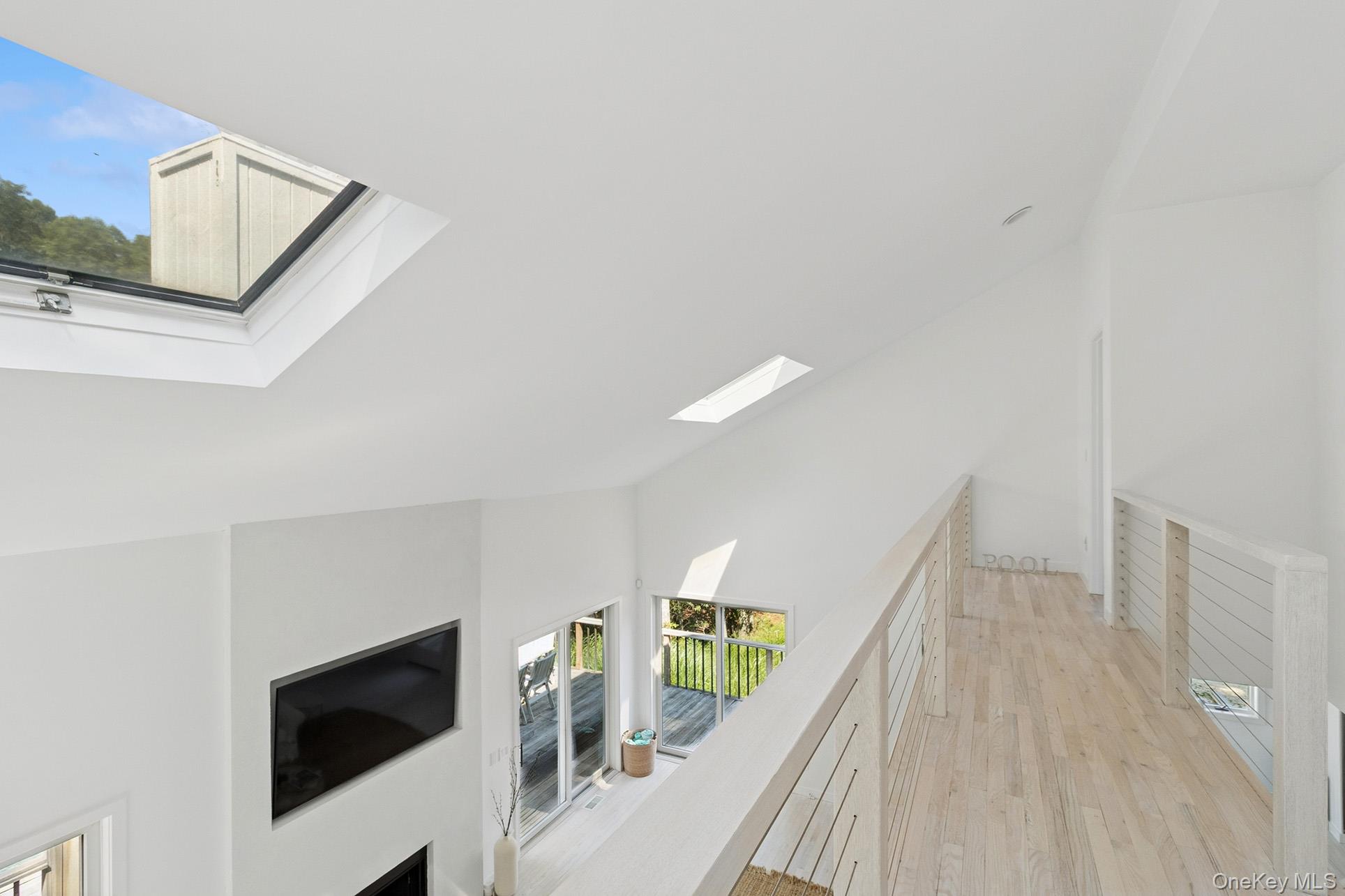 28 Ridge Road Wainscott, NY 11937 - Photo 35 of 40 a view of a livingroom with wooden floor and stairs