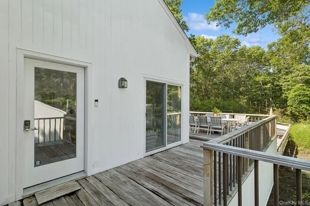 a view of a balcony with wooden floor and fence