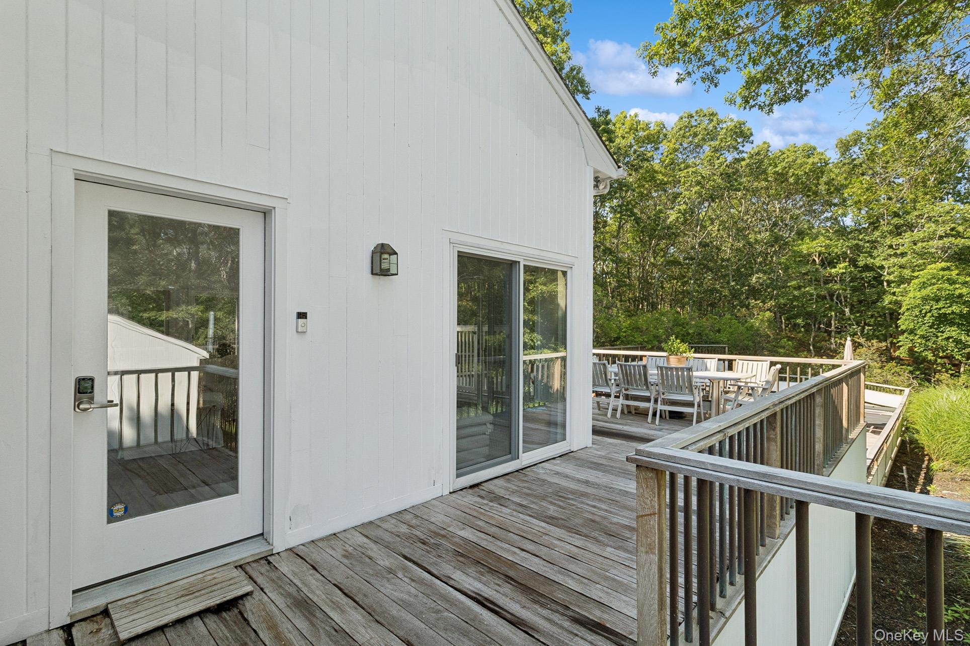 28 Ridge Road Wainscott, NY 11937 - Photo 9 of 40 a view of a balcony with wooden floor and fence