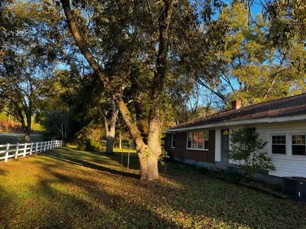 a view of a house with backyard and sitting area