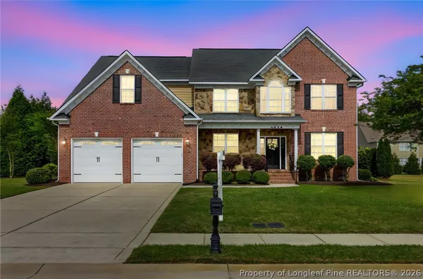 an aerial view of a house with a swimming pool and outdoor seating