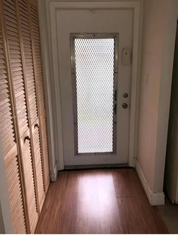 a view of a room with wooden floor and chair