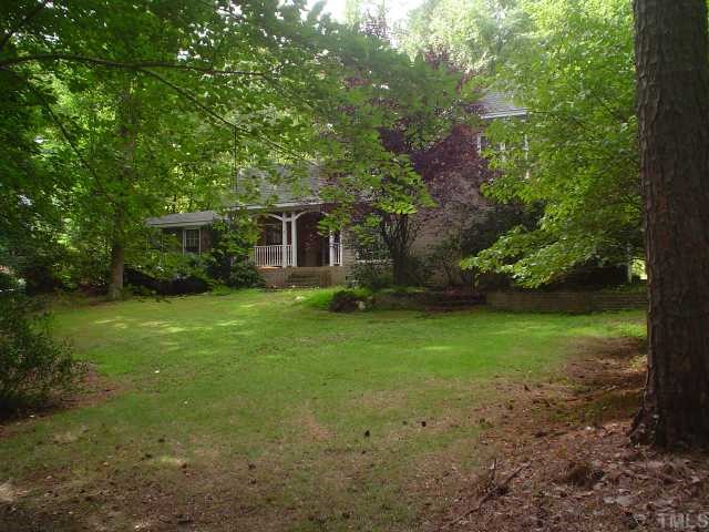 2513 Saddleridge Drive Raleigh, NC 27615 - Photo 3 of 3 a view of a backyard with plants and large trees