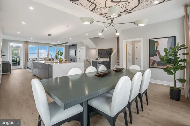 a dining room with furniture and wooden floor