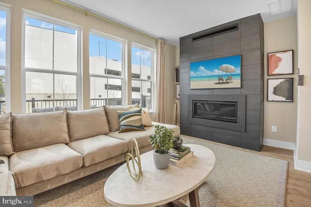 a living room with furniture a fireplace and a flat screen tv