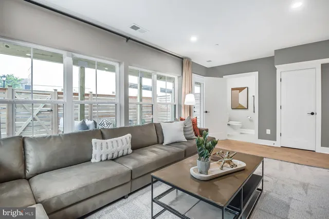 a living room with furniture and a large window