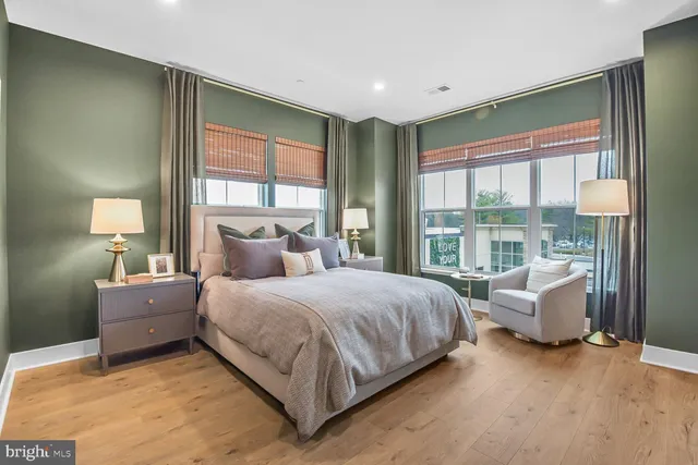 a bedroom with a bed and glass window