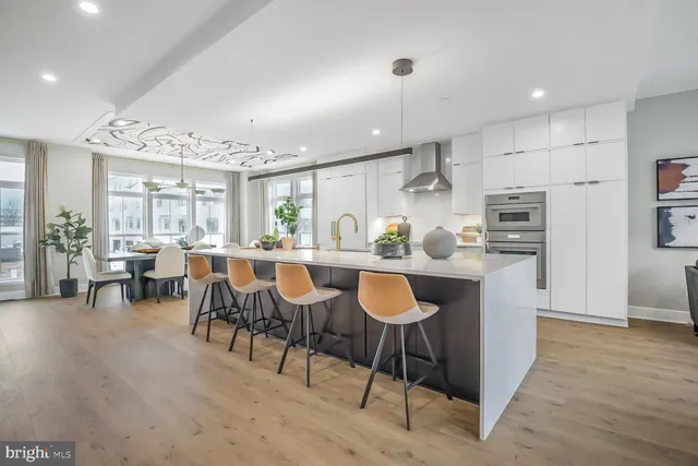 a kitchen with kitchen island granite countertop wooden cabinets and stainless steel appliances