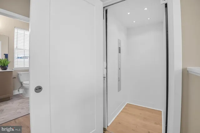 a bathroom with a granite countertop sink toilet a large mirror a shower and a bathtub