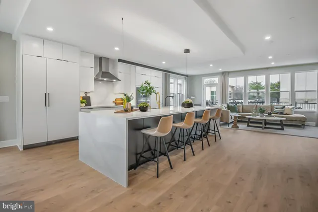 a large dining hall with stainless steel appliances granite countertop a stove and a living room view