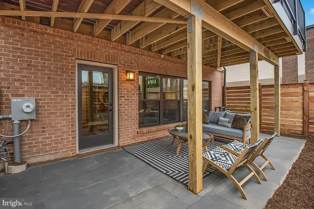 a view of a balcony with couch and wooden floor