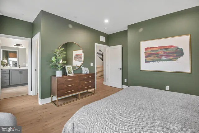 a bedroom with a bed and a dresser