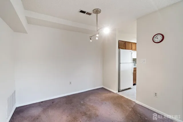 a large white kitchen with a stove and a refrigerator