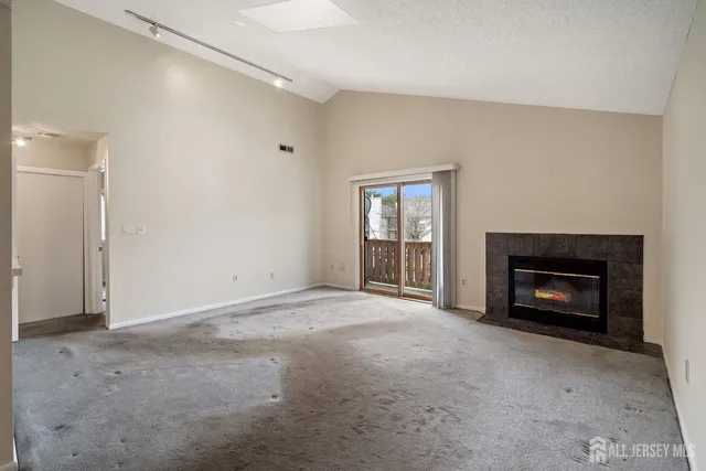 a view of a livingroom with an empty space and a fireplace